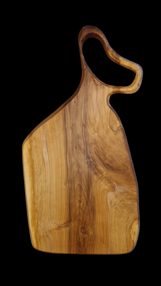 Handcrafted live edge Applewood charcuterie board with warm orange and brown wood tones.