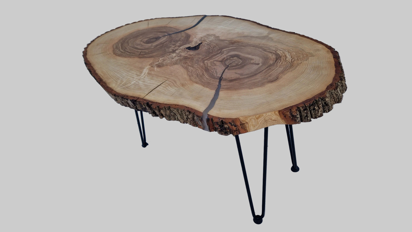 Wooden coffee table with a natural finish on a textured surface