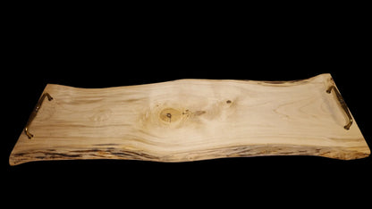 Top view of a long 90cm maple wood live edge serving board with vintage brass handles on a neutral background